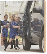 Children In Soccer Outfits Getting Into Car Wood Print