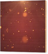 Christmas Background, De-focused Gold Colored Particles On Red Background With Lens Flare Wood Print