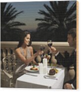 Couple In Evening Wear Having Dinner On Balcony, Toasting With Red Wine Wood Print