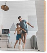 Father And Son Playing Soccer In The Living Room Wood Print