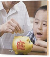Father And Son Saving Coins Into A Piggy Bank Wood Print