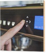 Finger Pushing Digital Button On Coffee Machine Wood Print