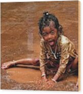 Girl In The Puddle Of Brown Water Wood Print