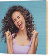 Girl On A Blue Background Rejoices At Her Success Wood Print