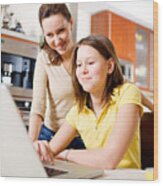 Happy Mother With Daughter Using Laptop At Home Wood Print
