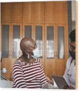 Health Visitor And A Senior Woman During Nursing Home Visit Wood Print