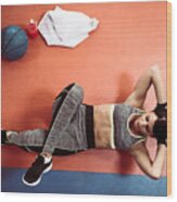 Healthy Female Athlete Doing Crunches In Gym From Above Wood Print