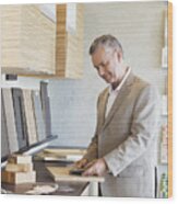 Man Looking At Samples Of Wood Wood Print