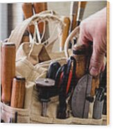 Man Selecting A Hand Tool From A Bag On Workbench Wood Print