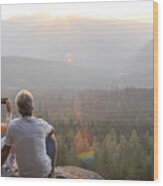 Mature Couple Relax On Mountain Ledge, Look Out To View Wood Print