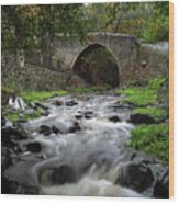 Medieval Stoned Bridge Water Flowing In The River. Wood Print