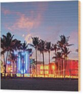 Miami Beach Ocean Drive Panorama With Hotels And Restaurants At Sunset. City Skyline With Palm Trees At Night. Art Deco Nightlife On South Beach Wood Print
