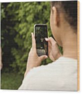 Mixed-race Teenage Sisters Filming With Mobile Phone In Backyard. Wood Print