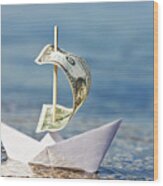 Paper Boat With $1 Bill Sail Is Blown Onshore Wood Print