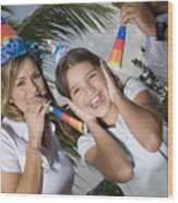 Portrait Of A Girl Laughing With Her Parents Blowing Party Horn Blowers Wood Print