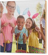 Portrait Of Five Children Wearing Bunny Ears On Easter Egg Hunt In Garden Wood Print