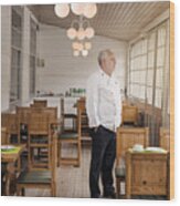 Restaurant Owner Standing In His Empty Restaurant. Wood Print