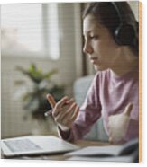 Teenage Girl With Headphones Having Online School Class At Home Wood Print