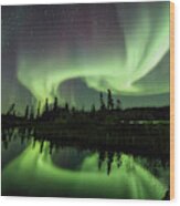 The Northern Lights Are Reflected In An Icy Lake In Canada Wood Print