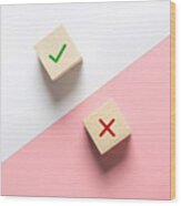 True And False Symbols Accept Rejected For Evaluation, Yes Or No On Wood Blogs On Pink And White Background. Wood Print