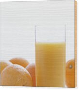 Whole Oranges By Orange Juice In Glass, Close-up Wood Print