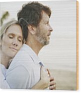 Wife Embracing Husband On Beach At Sunset Wood Print
