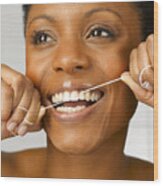 Woman Cleaning Teeth With Dental Floss, Close Up, Studio Shot Wood Print