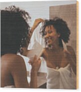 Woman In Bathroom Combing Hair Wood Print