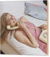 Woman Lying On A Bed Using A Telephone Wood Print