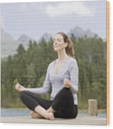 Woman Practicing Yoga On Pier By Lake Wood Print