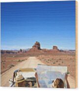 Women Reading Map In Convertible On Remote Road Wood Print