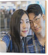 Young Asian Couple Taking Selfie Pictures In Airport Wood Print
