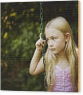 Young Girl Sitting On Swing Looking Out Wood Print