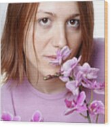 Young Woman Smelling Orchid, Portrait, Close Up Wood Print