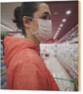 Young Woman Wears Medical Mask Against Virus While Grocery Shopping In Supermarket, Wood Print