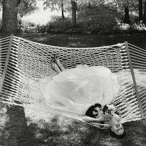 A Model Lying On A Hammock by Gene Moore