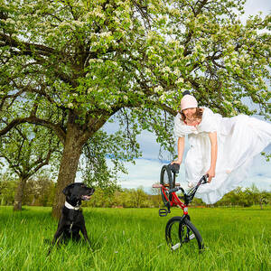 BMX Flatland Bride jumps in spring meadow by Matthias Hauser