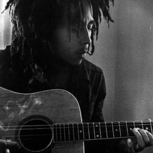Bob Marley Leaning Over Guitar by Retro Images Archive