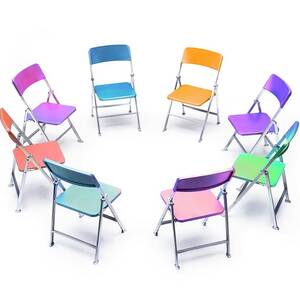 Circle Of Chairs Of Different Colours by Science Photo Library