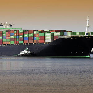 Container Ship And Tug Boat by Science Photo Library