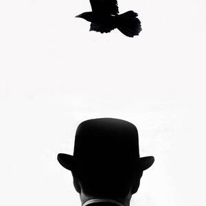 Crow Flying Over Man by Grant Faint