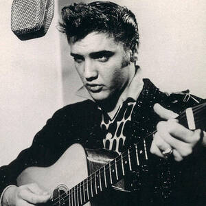 Elvis Presley Plays And Sings Into Old Microphone by Retro Images Archive
