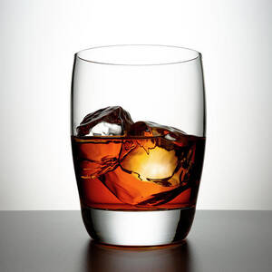 Glass With Brown Liquor And Ice Cubes by Chris Stein