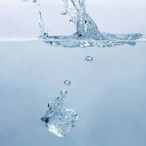 Ice Cube Splashing Into Water by Ballyscanlon