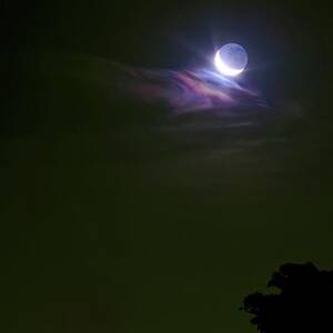 Moon Shining On Clouds by Science Photo Library