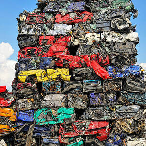 Pile of scrap cars on a wrecking yard by Matthias Hauser