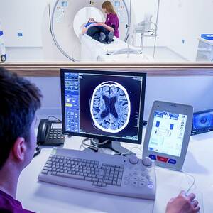Radiographer Viewing A Ct Scan by Science Photo Library
