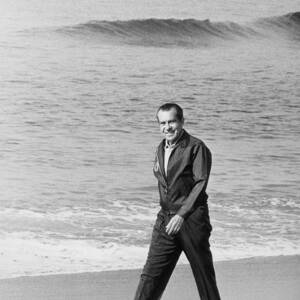 Richard Nixon Walking On The Beach by Everett