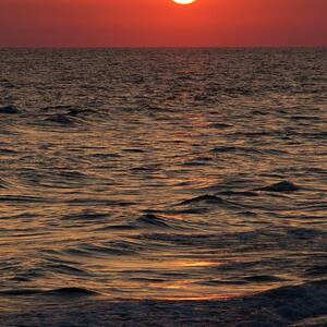 Sunset Over The Ocean And A Beach by Science Photo Library