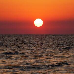Sunset Over The Ocean by Science Photo Library